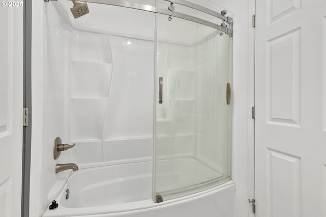 bathroom featuring shower / bath combination with glass door