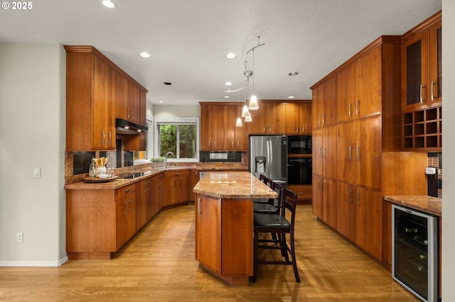 22767 SW Saunders Dr, Sherwood, OR 97140 - kitchen featuring beverage cooler, stainless steel fridge with ice dispenser, brown cabinets, a kitchen island, and recessed lighting