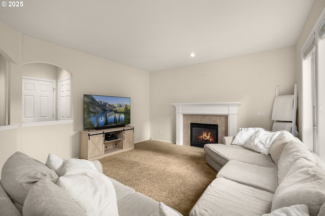 22767 SW Saunders Dr, Sherwood, OR 97140 - living room featuring carpet flooring, a tiled fireplace, arched walkways, and recessed lighting