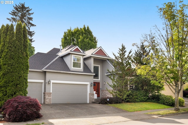 22767 SW Saunders Dr, Sherwood, OR 97140 - traditional home with brick siding, an attached garage, driveway, and a front yard