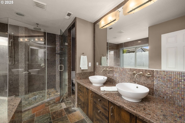22767 SW Saunders Dr, Sherwood, OR 97140 - full bath with a wall mounted air conditioner, a shower stall, double vanity, tasteful backsplash, and stone finish flooring