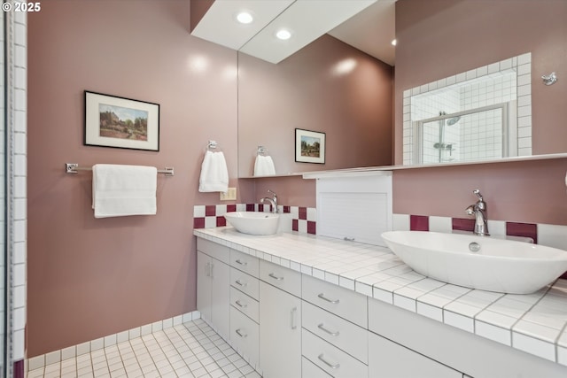 bathroom with double vanity, a sink, recessed lighting, and a shower stall