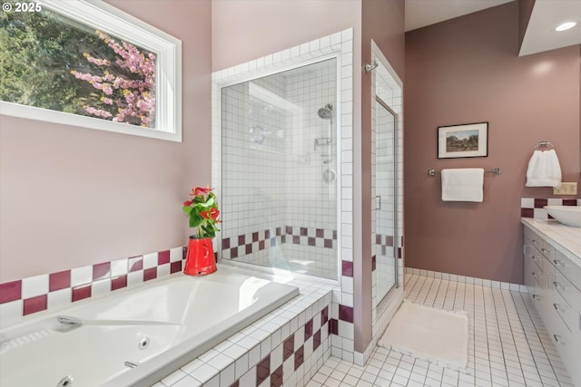 bathroom with a jetted tub, tile patterned floors, vanity, and a shower stall