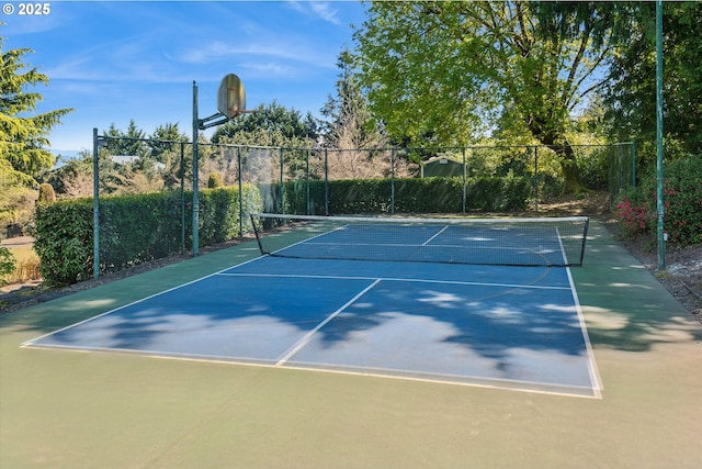 view of tennis court featuring fence