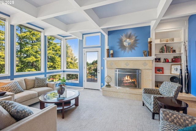 carpeted living area with beam ceiling, a high end fireplace, and coffered ceiling