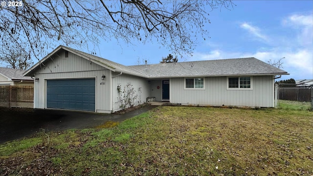 ranch-style home featuring a front lawn, an attached garage, and fence