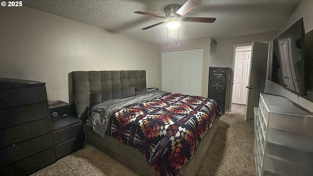 carpeted bedroom with ceiling fan, a closet, and a textured ceiling