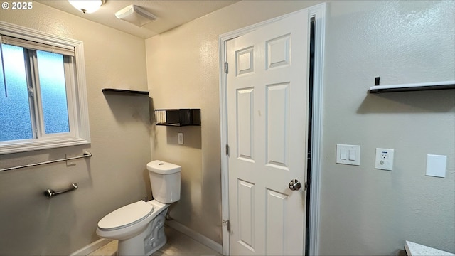 bathroom with toilet, visible vents, and baseboards