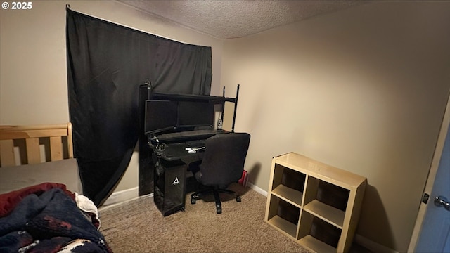 office area featuring a textured ceiling, carpet, and baseboards