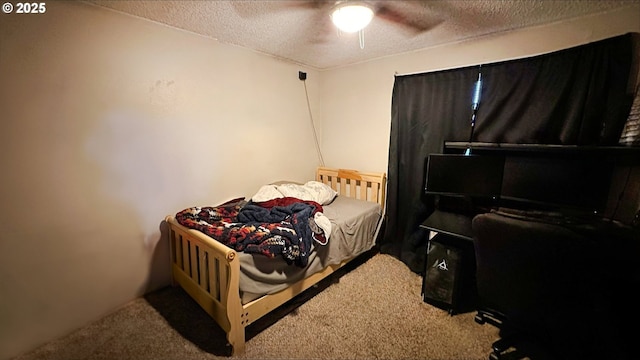 bedroom with carpet, ceiling fan, and a textured ceiling