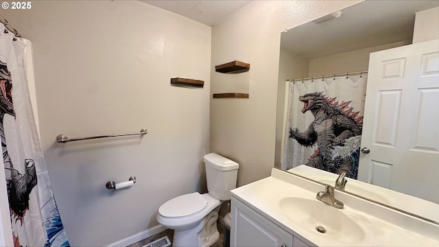 full bathroom with baseboards, vanity, and toilet