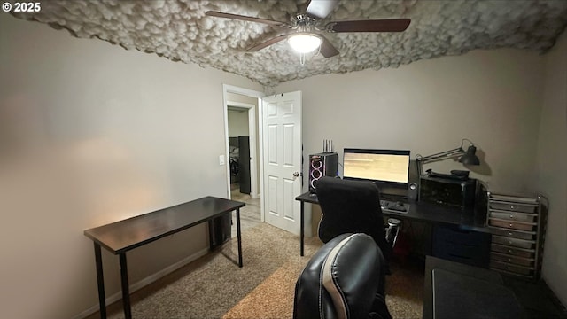 carpeted office space featuring ceiling fan