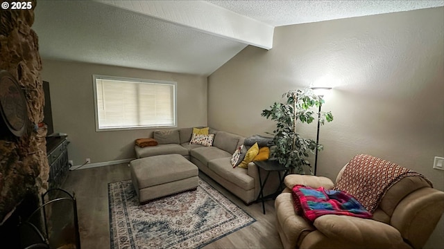 living area with baseboards, lofted ceiling with beams, a textured ceiling, and wood finished floors