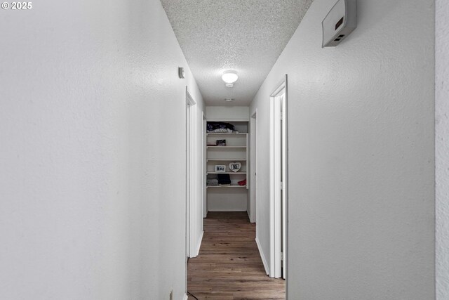 1030 Augustine Ave, Coos Bay, OR 97420 - corridor featuring a textured ceiling and wood finished floors