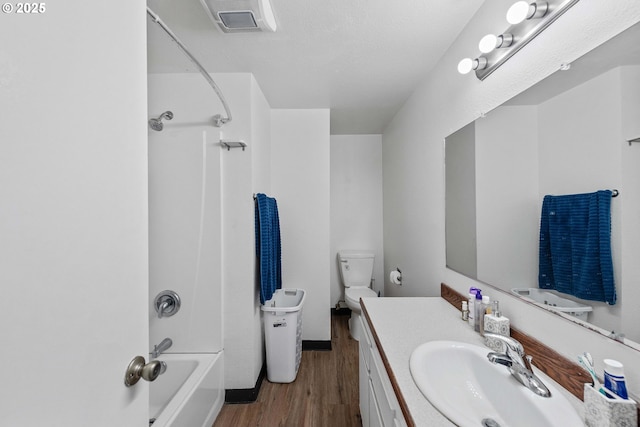 1030 Augustine Ave, Coos Bay, OR 97420 - bathroom with toilet, wood finished floors, vanity, visible vents, and tub / shower combination