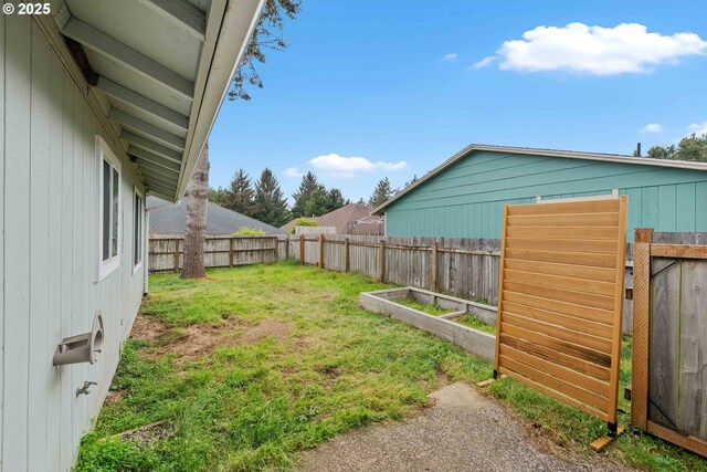 1030 Augustine Ave, Coos Bay, OR 97420 - view of yard featuring a garden and a fenced backyard