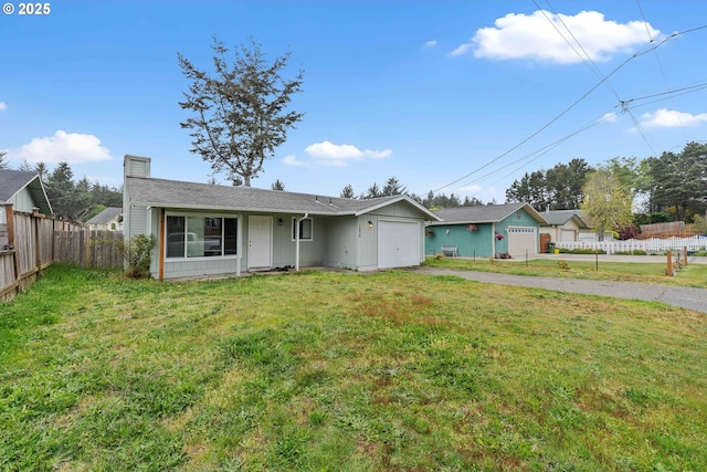 1030 Augustine Ave, Coos Bay, OR 97420 - ranch-style home with aphalt driveway, fence, a garage, a front lawn, and a chimney