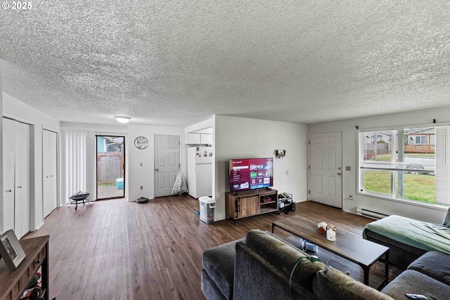 1030 Augustine Ave, Coos Bay, OR 97420 - living area featuring a baseboard heating unit, a textured ceiling, and wood finished floors