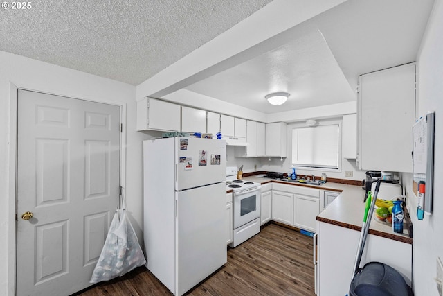 1030 Augustine Ave, Coos Bay, OR 97420 - kitchen with white appliances, white cabinets, a textured ceiling, and dark wood-type flooring