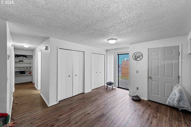 1030 Augustine Ave, Coos Bay, OR 97420 - unfurnished bedroom with a textured ceiling, access to outside, and dark wood-style floors
