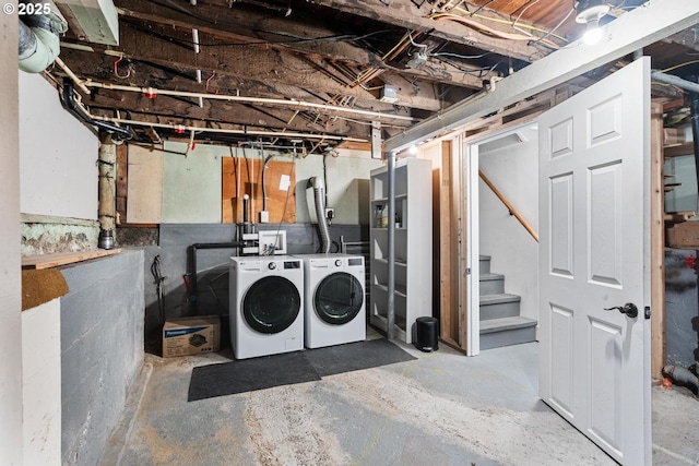 unfinished below grade area featuring washing machine and dryer and stairs
