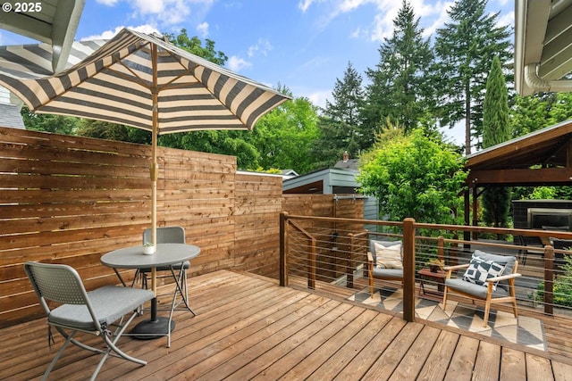 wooden terrace featuring fence