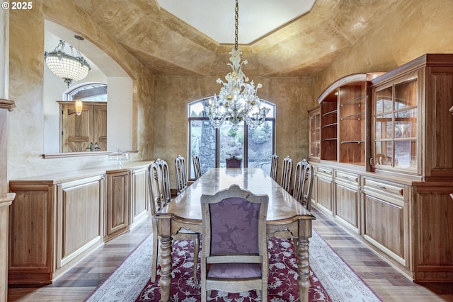 dining room featuring an inviting chandelier, a high ceiling, and dark wood-style flooring