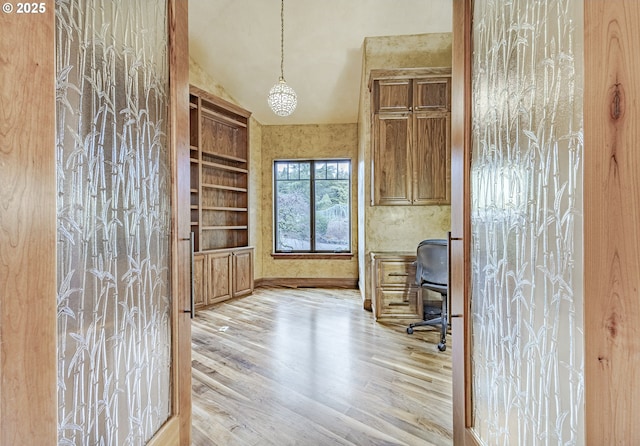 office area with lofted ceiling, light wood finished floors, and baseboards