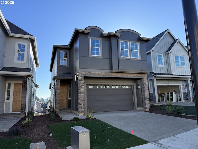 multi unit property with a garage, concrete driveway, stone siding, stucco siding, and board and batten siding