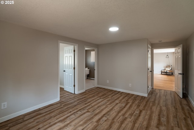 14424 SE Bevington Ct, Milwaukie, OR 97267 - unfurnished room featuring dark wood-style flooring, a textured ceiling, and recessed lighting