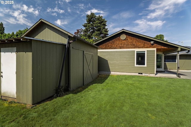 14424 SE Bevington Ct, Milwaukie, OR 97267 - view of side of property with a yard, an outbuilding, and a patio