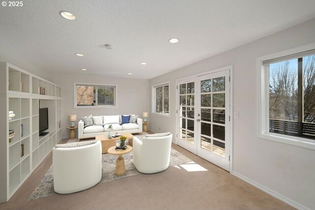 4045 SW Jerald Ct, Portland, OR 97221 - carpeted living area featuring healthy amount of natural light, recessed lighting, baseboards, and french doors