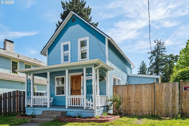 10006 N Calhoun Ave, Portland, OR 97203 - view of front facade with a porch and fence