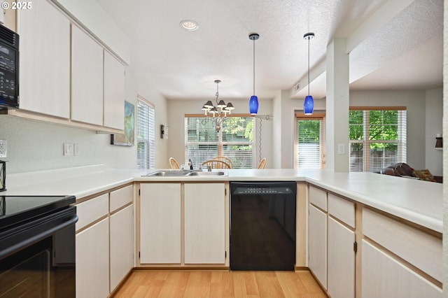 4701 NE 77th Ave, Vancouver, WA 98662 - kitchen with black appliances, a sink, a chandelier, light wood finished floors, and light countertops