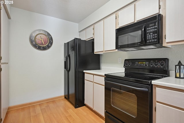 4701 NE 77th Ave, Vancouver, WA 98662 - kitchen featuring black appliances, light countertops, light wood-style flooring, and baseboards