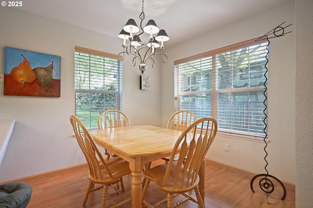 4701 NE 77th Ave, Vancouver, WA 98662 - dining room featuring a chandelier, healthy amount of natural light, light wood-type flooring, and baseboards