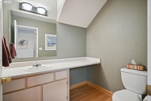 4701 NE 77th Ave, Vancouver, WA 98662 - half bath with wood finished floors, toilet, baseboards, vanity, and a textured wall