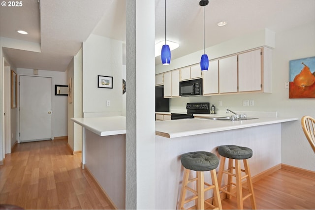 4701 NE 77th Ave, Vancouver, WA 98662 - kitchen featuring black appliances, light wood-style flooring, a sink, baseboards, and recessed lighting