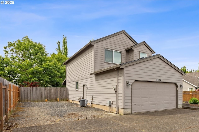 14644 SE Sterling Ct, Clackamas, OR 97015 - view of side of property featuring a fenced backyard, driveway, and central AC