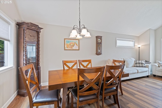14644 SE Sterling Ct, Clackamas, OR 97015 - dining area featuring a chandelier, wood finished floors, and baseboards