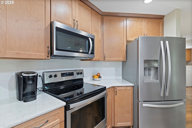 14644 SE Sterling Ct, Clackamas, OR 97015 - kitchen with stainless steel appliances, tasteful backsplash, light stone countertops, and wood finished floors