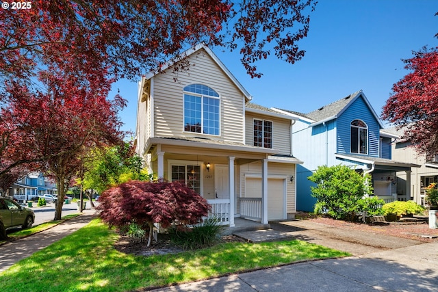 traditional-style house featuring an attached garage, a porch, and aphalt driveway