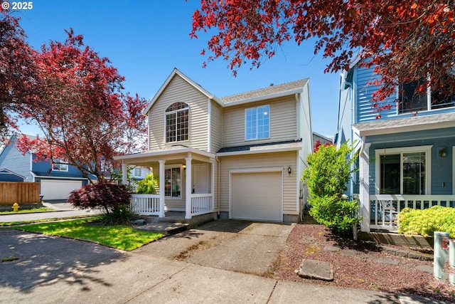 traditional-style house with an attached garage, covered porch, and concrete driveway