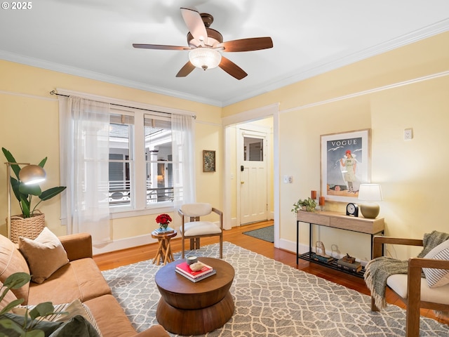 2127 NW Irving St Unit 104, Portland, OR 97210 - living area with wood finished floors, ornamental molding, a ceiling fan, and baseboards