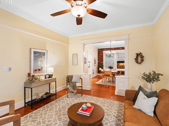 2127 NW Irving St Unit 104, Portland, OR 97210 - living area with wood finished floors, ornate columns, a ceiling fan, ornamental molding, and a chandelier