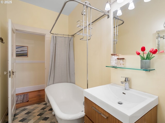 2127 NW Irving St Unit 104, Portland, OR 97210 - bathroom with a freestanding tub, vanity, a shower with shower curtain, and baseboards