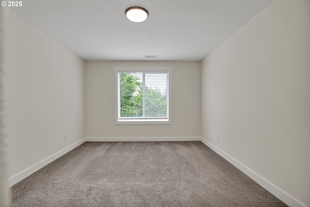 spare room with carpet floors and baseboards