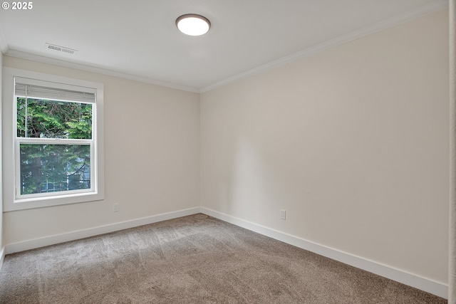 carpeted empty room with ornamental molding and baseboards