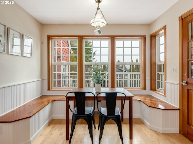 dining area with light hardwood / wood-style floors and breakfast area