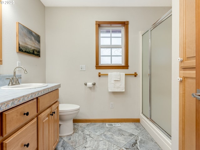 bathroom with toilet, walk in shower, and vanity